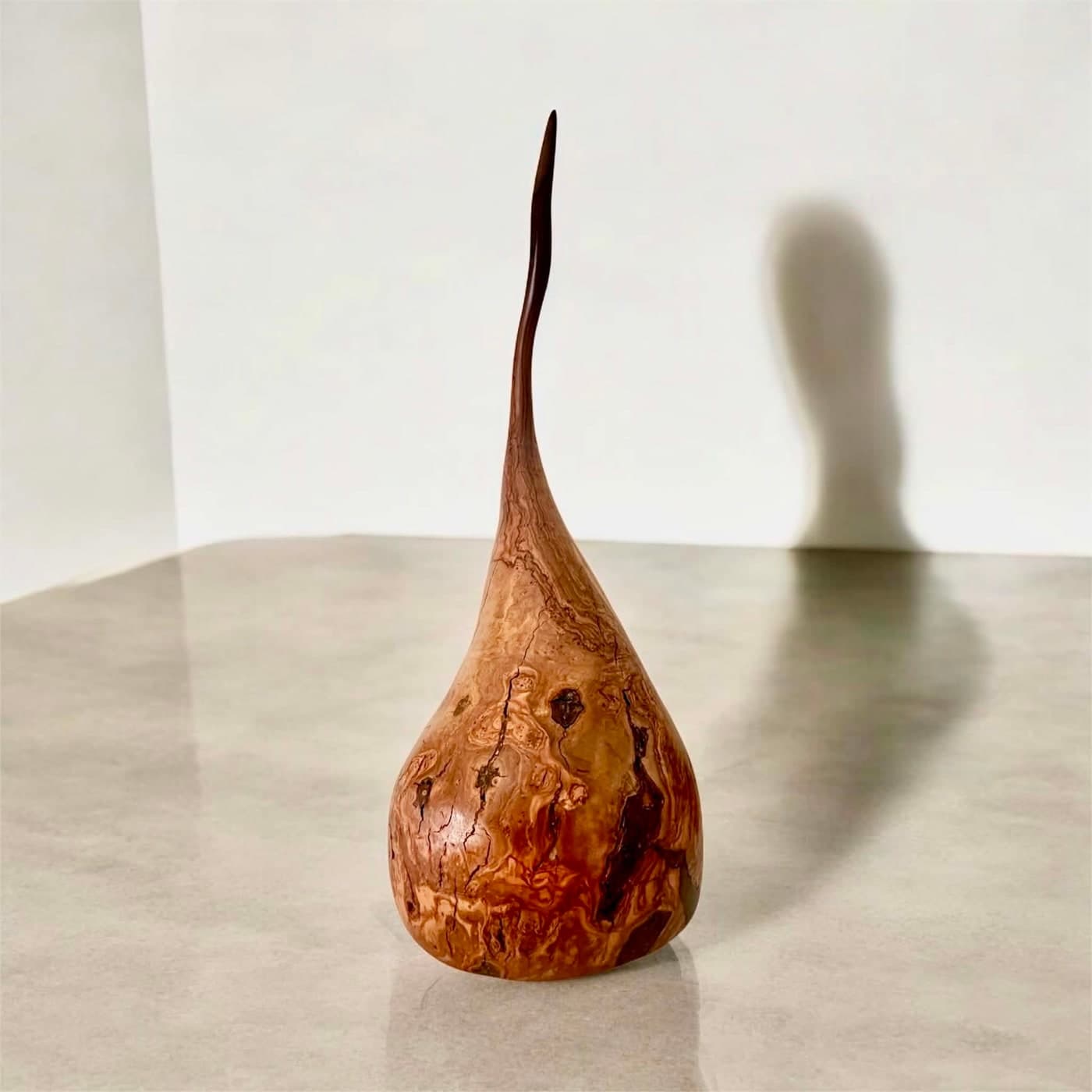 Teardrop timber sculpture photographed front-on in soft studio light
