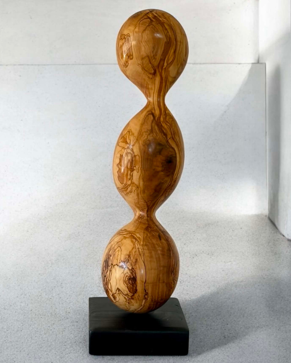 Tall pod-shaped olive wood sculpture